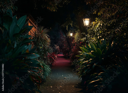 Illuminated leafy foliage night path Victorian street lamps