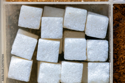 Принти на полотні Sweet white sugar cubes texture pattern in plastic bowl
