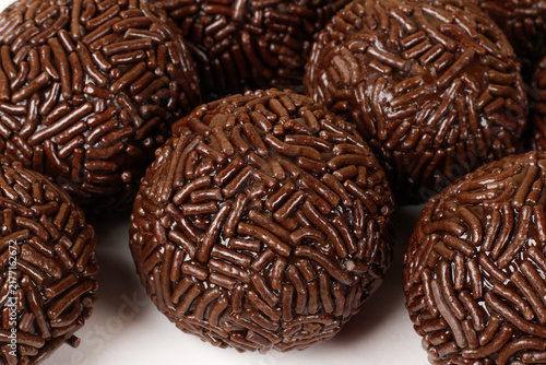 A serving of traditional Brazilian chocolate brigadeiros coated in sprinkles. A popular treat at parties and celebrations.