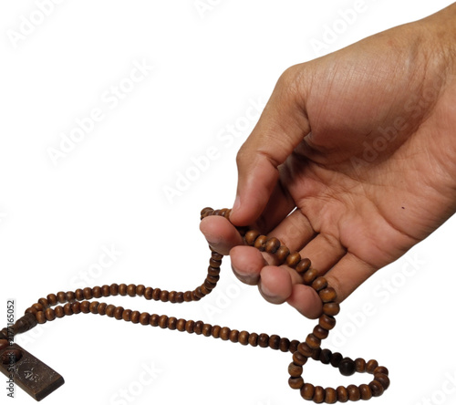 фотографія hand holding brown wooden prayer beads or tasbih