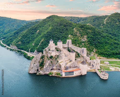 Фотография Golubac Fortress perched on rocky cliffs overlooking the Danube gorge amid lush