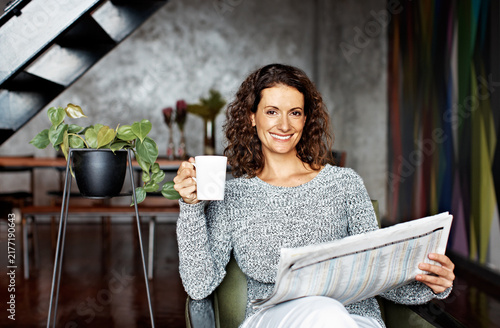 фотографія Newspaper, portrait and coffee with woman on sofa for article, headline announcement and update