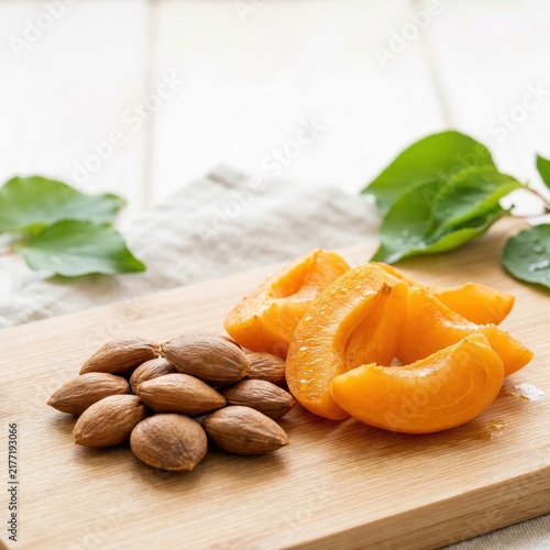 Fresh sliced apricots with seeds on a rustic wooden board with copy space.