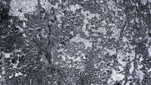 Fotografie Aged concrete wall with visible block joints, rough plaster texture, cracks, and weathering marks in black and white monochrome