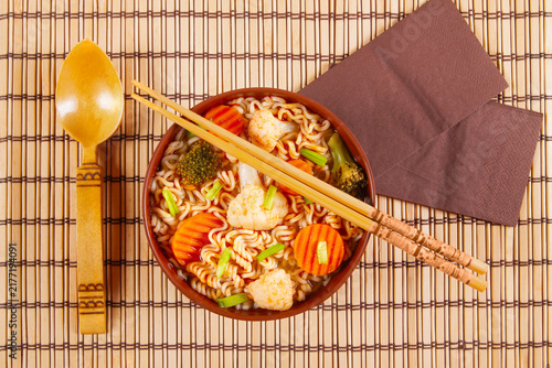 Serving Asian dishes at restaurant in bowl on bamboo mat