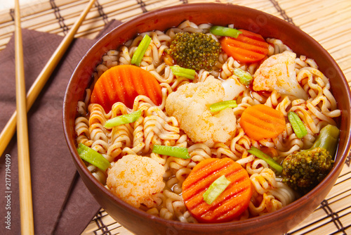 Close-up of Asian ramen noodles presented in clay bowl