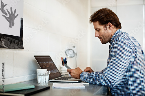 Foto Laptop, phone and reading with business man in office for account review, budget treasurer and planning