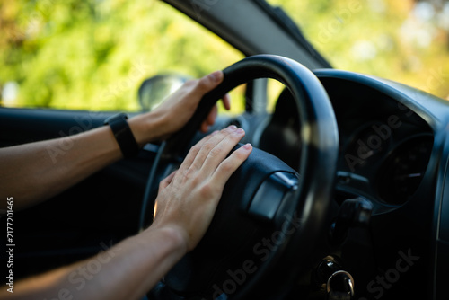 Driver honking car horn showing frustration and road rage