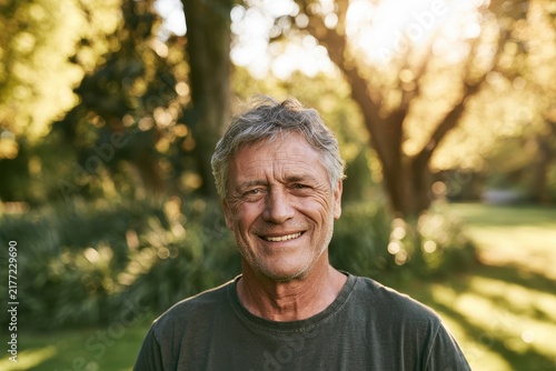 Relaxed outdoor head-and-shoulders portrait of a mature man in nature