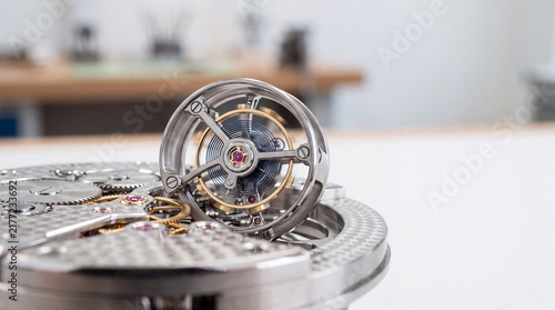Close-up of luxury mechanical watch movement with exposed tourbillon and precision gears
