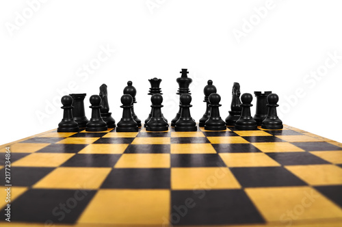 Black chess pieces arranged on a wooden board.