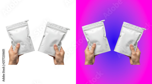 Bild auf Leinwand Two hands holding small white empty pouches with zipper seals, shown on a white