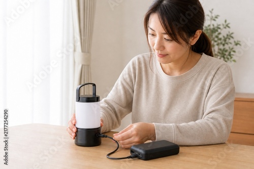 Tapety artystyczne 停電に備えて充電式照明を準備する日本人女性