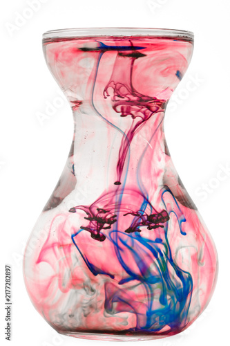 Photography Interpenetrating layers of colored streaks inside a glass vessel of water, color