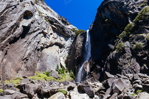 Konstfotografi Lower Yosemite Fall plunging down granite cliffs into boulder field in Yosemite