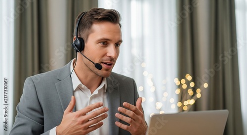 Man in Suit and Headset Talking on Video Call on Laptop, Gesturing Actively During Online