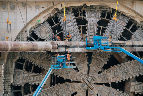 Construction workers operating a tunnel boring machine