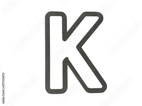 Obraz na plátne Uppercase letter k with a dark grey dotted pattern texture inside isolated on tr