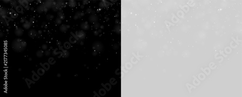 Numerous small glowing particles float over a deep black background. The light points vary softly in size and intensity, creating a subtle bokeh effect.