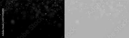 Fine white dust particles float softly against a black background. The scattered specks vary in size and brightness, creating a gentle glowing effect. This image can be used to depict air.
