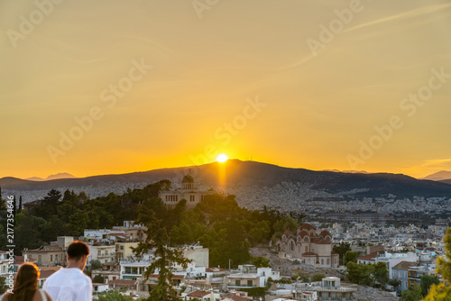 Golden sunset over Athens with National Observatory and Church of Agia Marina