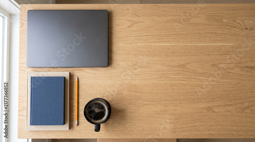 Minimalist workspace with laptop notebook and coffee on wooden desk top view