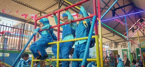 Obraz na płótnie Baubau, Southeast Sulawesi, September 1, 2026, 3 elementary school children were climbing the iron games at the school