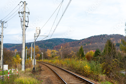 Cuadro en lienzo Single electrified railway track curves through dense autumn vegetation near Jezioro Mucharskie and Stryszow