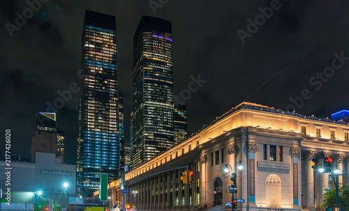 Moynihan Train Hall with skyscrapers at night in New York
