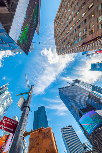 New York City skyscrapers viewed from below under blue sky