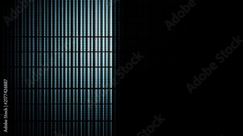 Industrial metal grate with strong directional light and deep shadow creating a modern abstract pattern