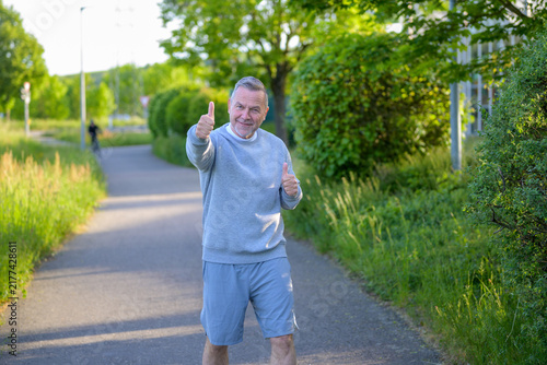 Happy Senior Showing Double Thumbs
