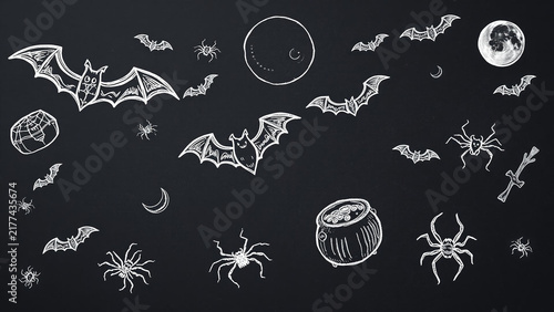 Halloween chalkboard background with handdrawn bats, spiders, moons, and a cauldron, perfect for spooky holiday designs and festive party invitations