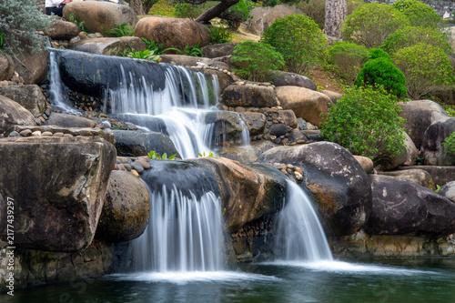 Flowing Water Over Smooth Eroded Rocks in a Natural Waterfall