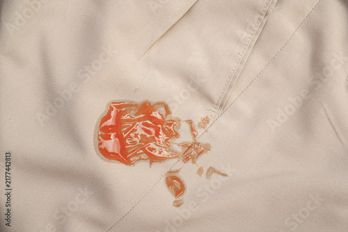 Fotografie red tomato ketchup stain on khaki fabric