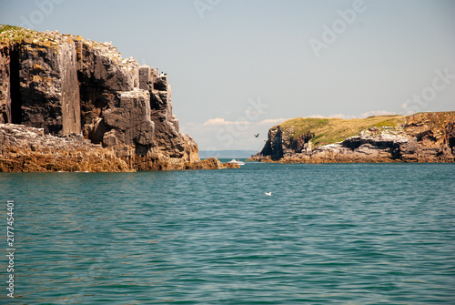 Bild auf Leinwand Sunny summer day at Tenby Beach Wales – golden sand, turquoise sea, people swimm