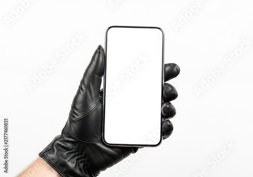 Hand wearing black glove holding smartphone