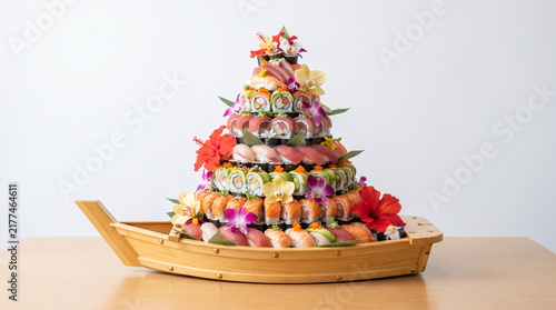 close up vibrant sushi boat arrangement with flower garnishes, layered rolls, red purple green colors, intricate