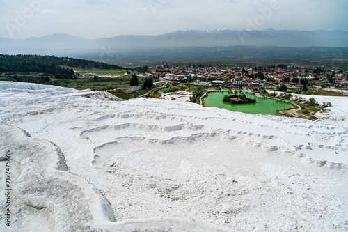 White travertine terraces of Pamukkale overlooking the lake near the town of Pamukkale a world-famous natural wonder and thermal springs Denizli Province, Türkiye 