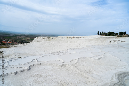 White travertine terraces of Pamukkale overlooking the lake near the town of Pamukkale a world-famous natural wonder and thermal springs Denizli Province, Türkiye 