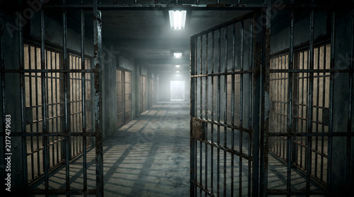 Dark prison corridor with metal cell bars and moody cinematic lighting in a detention center