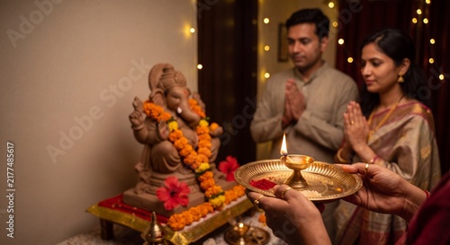 Authentic Indian Family Performing Ganesh Chaturthi Aarti at Home with Copy Space