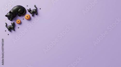 Halloween decorations spilling from corner onto pastel background
