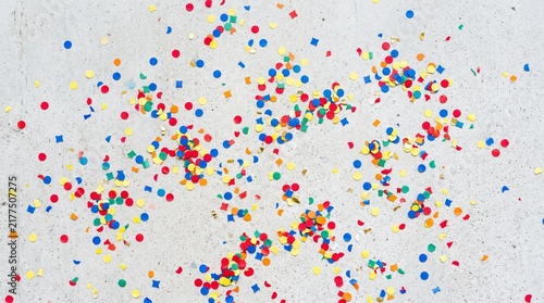 Colorful Confetti Scattered on a Light Textured Surface