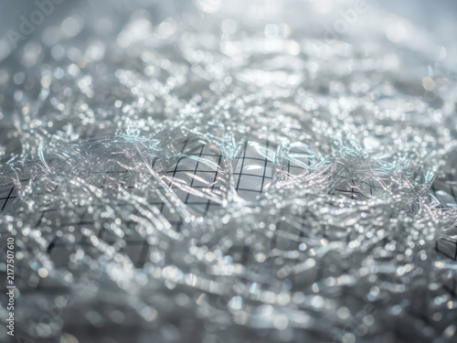 Clear plastic wrap texture over a black and white grid pattern design