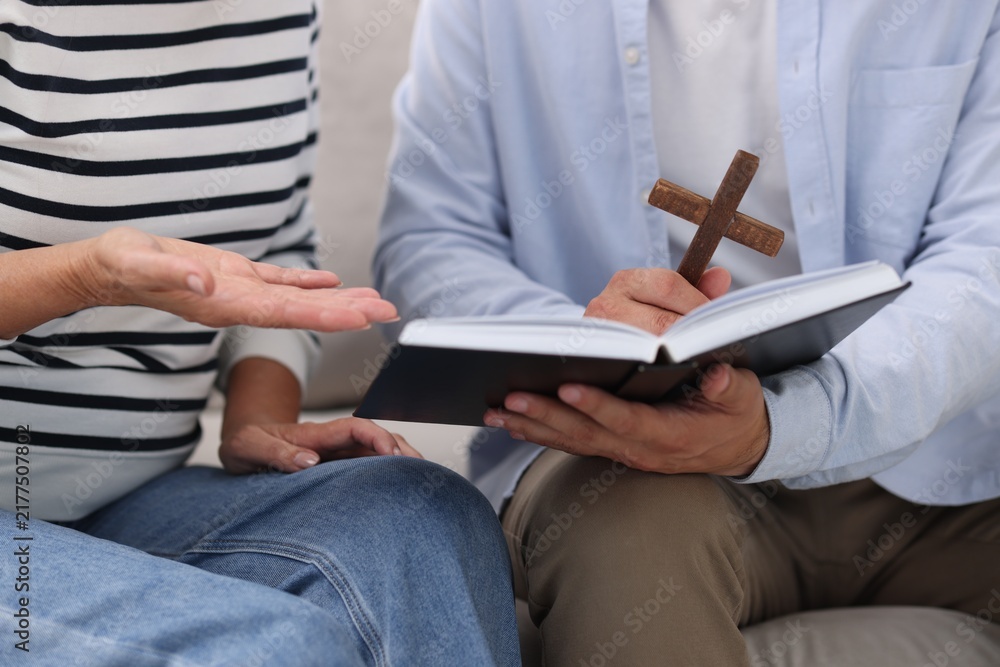 Fototapeta premium Pastor conducting Bible study with senior woman at home, closeup