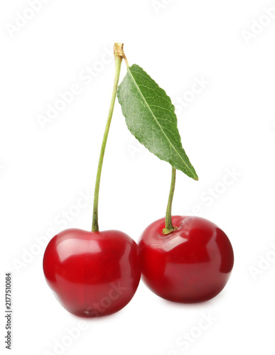 Fresh ripe cherries with green leaf isolated on white