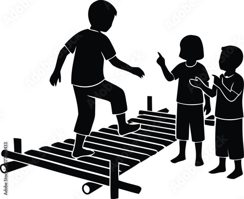 Bild auf Leinwand Silhouette of children playing on a makeshift plank bridge over logs childhood o