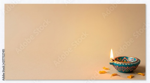 A single glowing clay diya lamp placed on a soft background for the traditional indian festival of diwali celebration