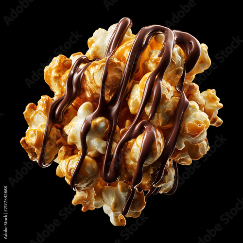 Chocolate popcorn cluster kernel coated in glossy golden caramel, isolated on black background, concept of gourmet snack food